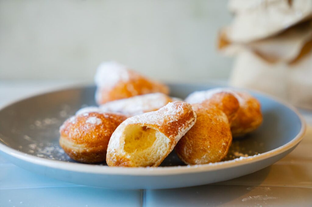 Close up of the hollow pilowy inside of a homemade beignet