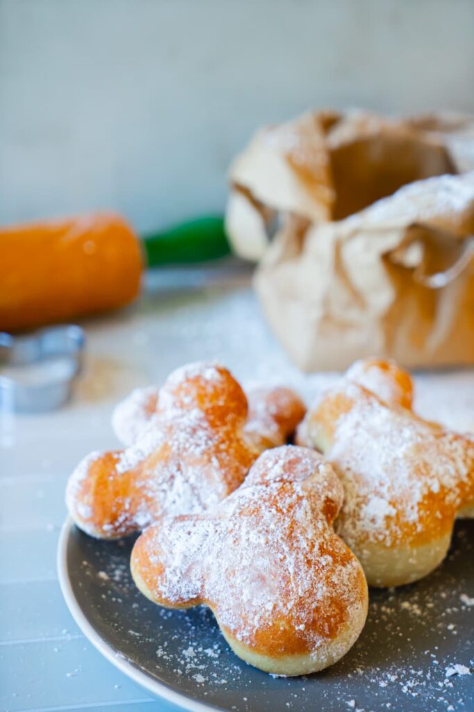 Close up of Mickey shaped beignets on a plate
