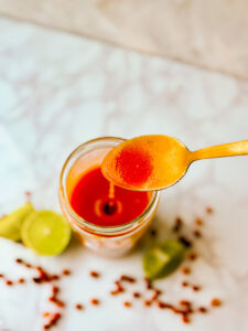 Drizzling spicy tangy chiltepin lime hot sauce