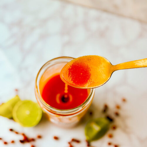 Drizzling spicy tangy chiltepin lime hot sauce
